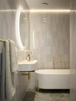 a bathroom with a tub and a sink and a mirror at Hotel 1904 in Ålesund