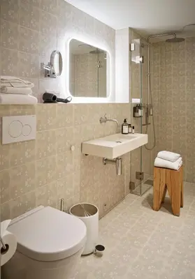 a bathroom with a toilet and a sink at Hotel 1904 in Ålesund