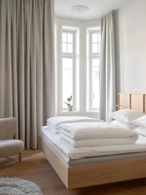 a bedroom with two beds and a window at Hotel 1904 in Ålesund