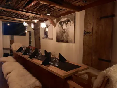 a long table in a room with a animal on the wall at Hafjell Hotell in Hafjell