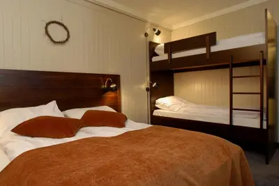 a bedroom with two beds and two bunk beds at Hafjell Hotell in Hafjell