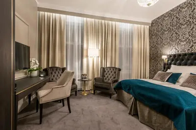 a hotel room with a bed and a desk at Home Hotel Grand Gjøvik in Gjøvik