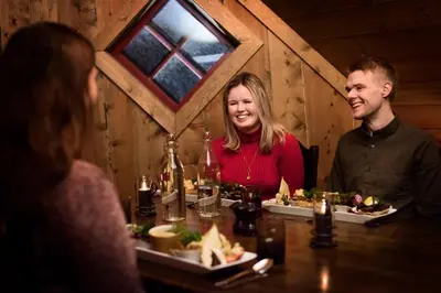 a group of people sitting at a table with food at Flåmsbrygga Hotel in Flåm