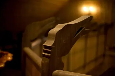 a wooden bench with a light on the wall at Flåmsbrygga Hotel in Flåm