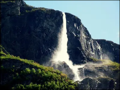 a waterfall on the side of a mountain at Gudvangen Fjordtell in Gudvangen