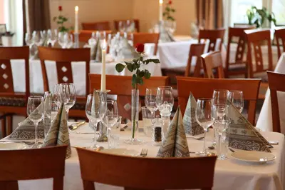 a table with wine glasses and napkins on it at Thon Hotel Selbusjøen in Selbu
