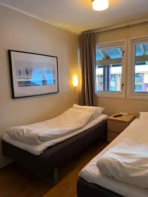 a room with two beds and a picture on the wall at Sandmoen Bed & Breakfast, Free Parking in Trondheim