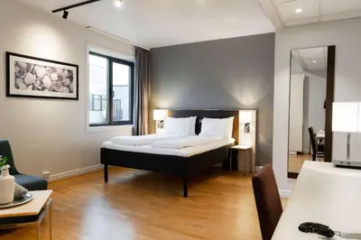 a bedroom with a bed and a desk and a chair at Scandic Alexandra Molde in Molde