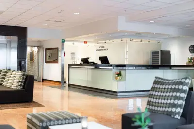 a lobby with a reception desk and a couch at Scandic Alexandra Molde in Molde