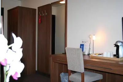 a room with a desk with a chair and a mirror at Thon Hotel Otta in Otta