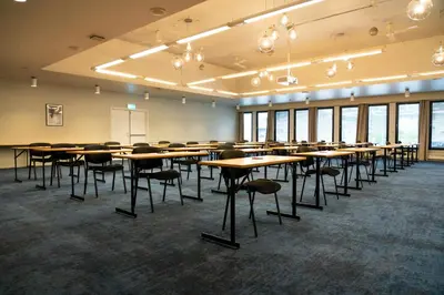 a classroom with tables and chairs in a room with windows at Thon Hotel Otta in Otta