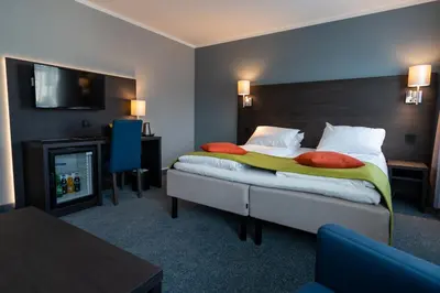 a hotel room with a bed and a fireplace at Thon Hotel Måløy in Måløy
