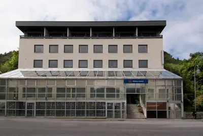 a large white building with a lot of windows at Thon Hotel Måløy in Måløy