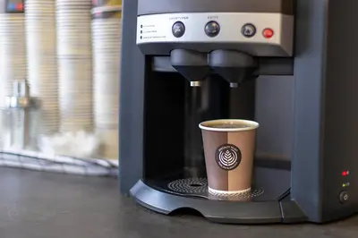 a cup of coffee in a coffee machine at Pensjonat Jarlen in Trondheim