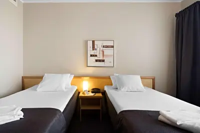a hotel room with two beds and a table at Stav Hotel in Malvik