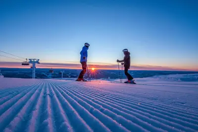 two people on skis in the snow at sunset at Trysil Hotel in Trysil