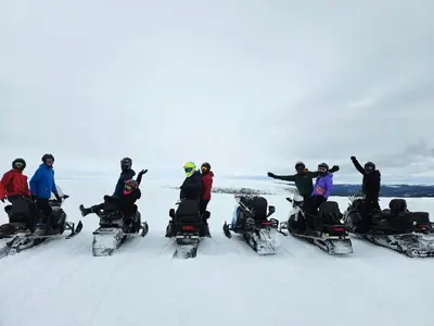 a group of people riding on snowmobils in the snow at Trysil Hotel in Trysil