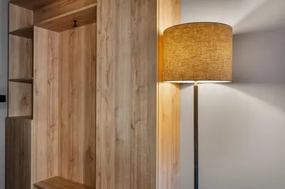 a lamp is next to a wooden wall at Trysil Hotel in Trysil