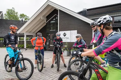a group of people on bikes in front of a building at Trysil Hotel in Trysil