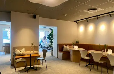 a restaurant with two tables and chairs and a counter at Comfort Hotel Park in Trondheim