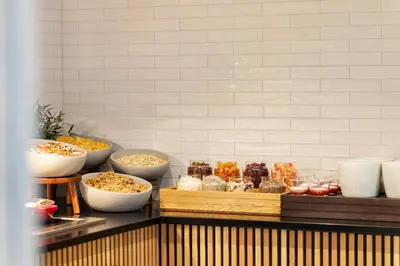 a buffet with bowls of food on a counter at Quality Hotel Augustin in Trondheim
