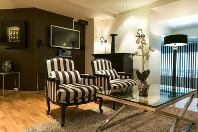 a living room with two chairs and a table at Quality Hotel Augustin in Trondheim