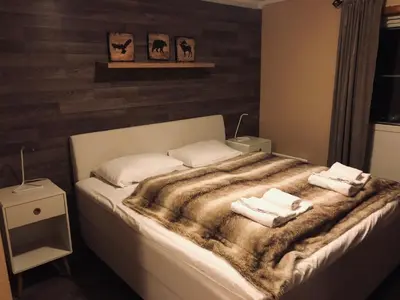 a bedroom with a bed with two towels on it at Kvitfjell Hotel Kvitfjellvegen 492 in Kvitfjell