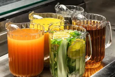a group of glass pitchers filled with different types of juice at Tyrifjord Hotell in Vikersund
