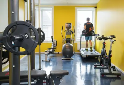 a man standing in a gym with some exercise equipment at Thon Hotel Nidaros in Trondheim