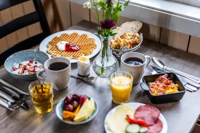 a table topped with plates of food and drinks at Håholmen - by Classic Norway Hotels in Karvåg
