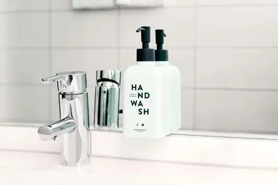 a bottle of shampoo next to a bathroom sink at Scandic Solsiden in Trondheim