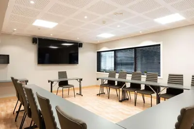 a conference room with a table and chairs at Scandic Solsiden in Trondheim