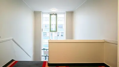 a room with a partition with a large window at City Living Sentrum Hotel in Trondheim