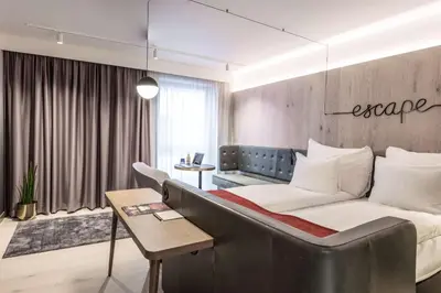 a hotel room with a bed and a couch at Hotel Norge by Scandic in Bergen