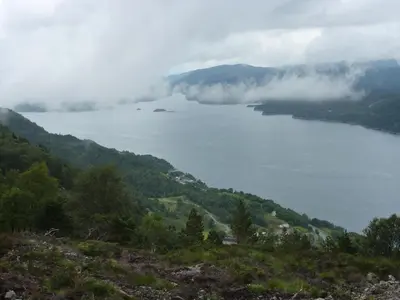 a view of a lake in the middle of a mountain at Langenuen Motel & Camping in Stord