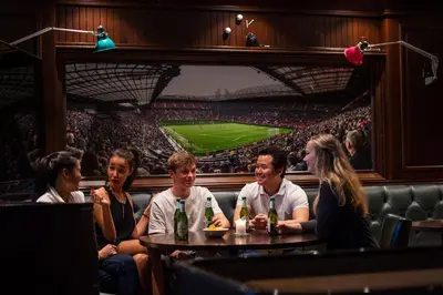 a group of people sitting at a table in a stadium at Dr. Holms Hotel in Geilo