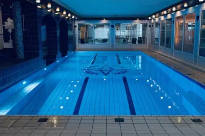 a swimming pool in a building with lights on it at Dr. Holms Hotel in Geilo