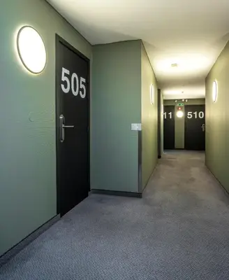 an empty hallway with a sign on the door at Thon Hotel Storgata in Kristiansund