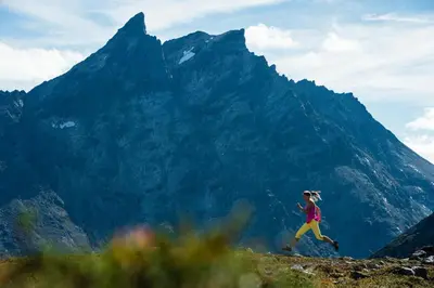 a woman running on a mountain with mountains in the background at Frich`s Hotel Surnadal in Surnadal