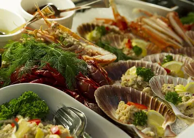 a table full of different types of seafood and vegetables at Fleischer's Hotel in Vossevangen