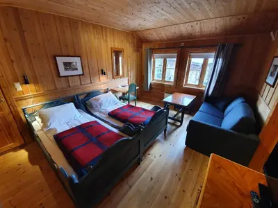an overhead view of a bedroom with a bed and a couch at Vertshuset Røros in Røros