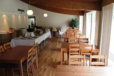 a dining room with wooden tables and chairs at Støren Hotel in Storen