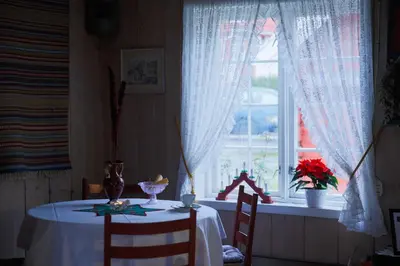 a dining room with a table and a window at Vangsgaarden Gjestgiveri in Aurland