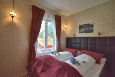 a bedroom with a large bed with a window at Vangsgaarden Gjestgiveri in Aurland