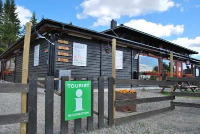 a wooden building with a sign in front of it at Nordseter Fjellpark, Hyttegrend in Nordseter