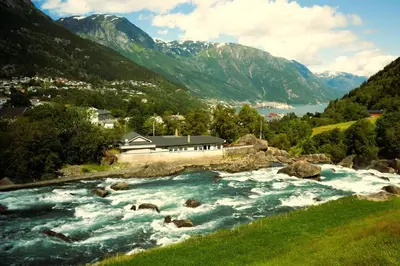 a river in a valley with mountains in the background at Trolltunga Hotel in Odda