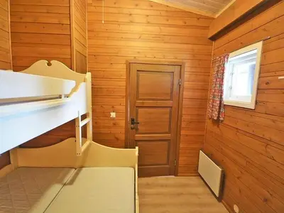 a room with wooden walls and a room with a door at Femundtunet in Drevsjø