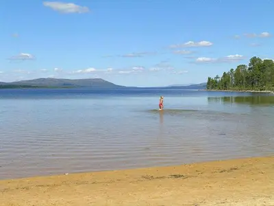 a person standing in the middle of a body of water at Femundtunet in Drevsjø