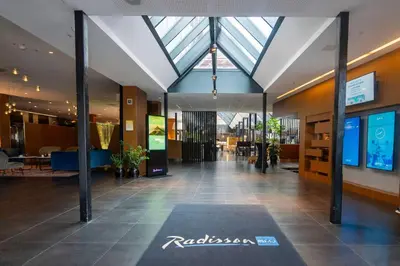 a lobby of a building with a rug on the floor at Radisson Blu Royal Hotel, Bergen in Bergen