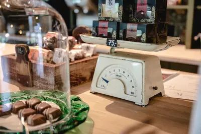 a scale sitting on a table with a plate of chocolateuts at Trolltun Hotel & Hytter in Dombås